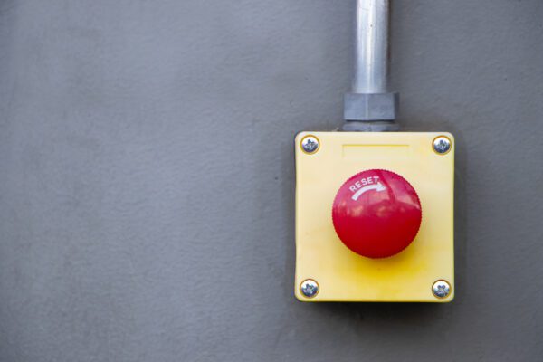 Discreet emergency panic button mounted under desk or office wall